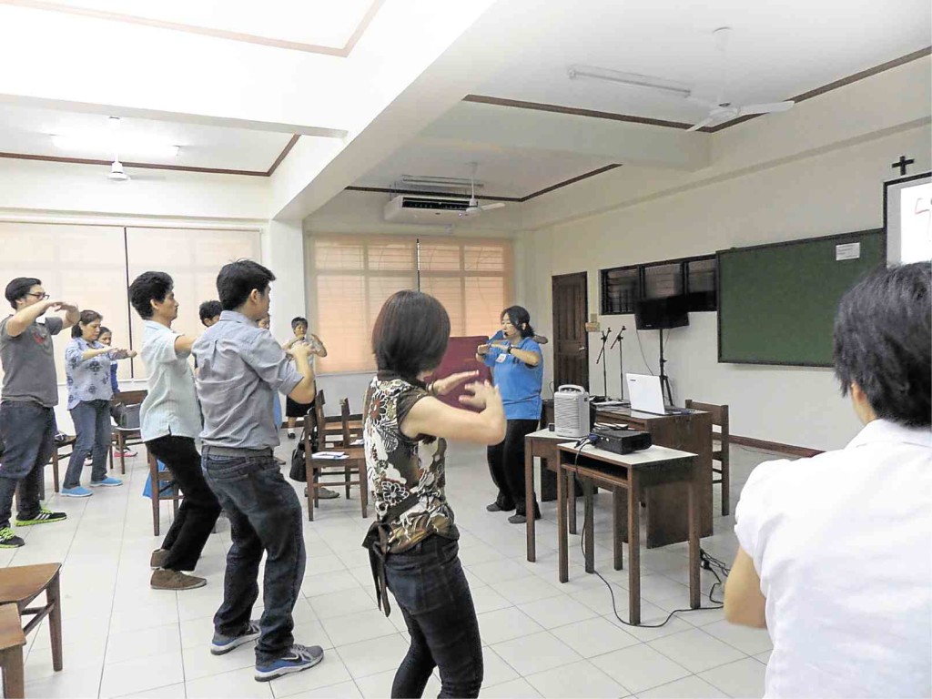 IRENE Chia guides participants through some “qi gong” exercises.