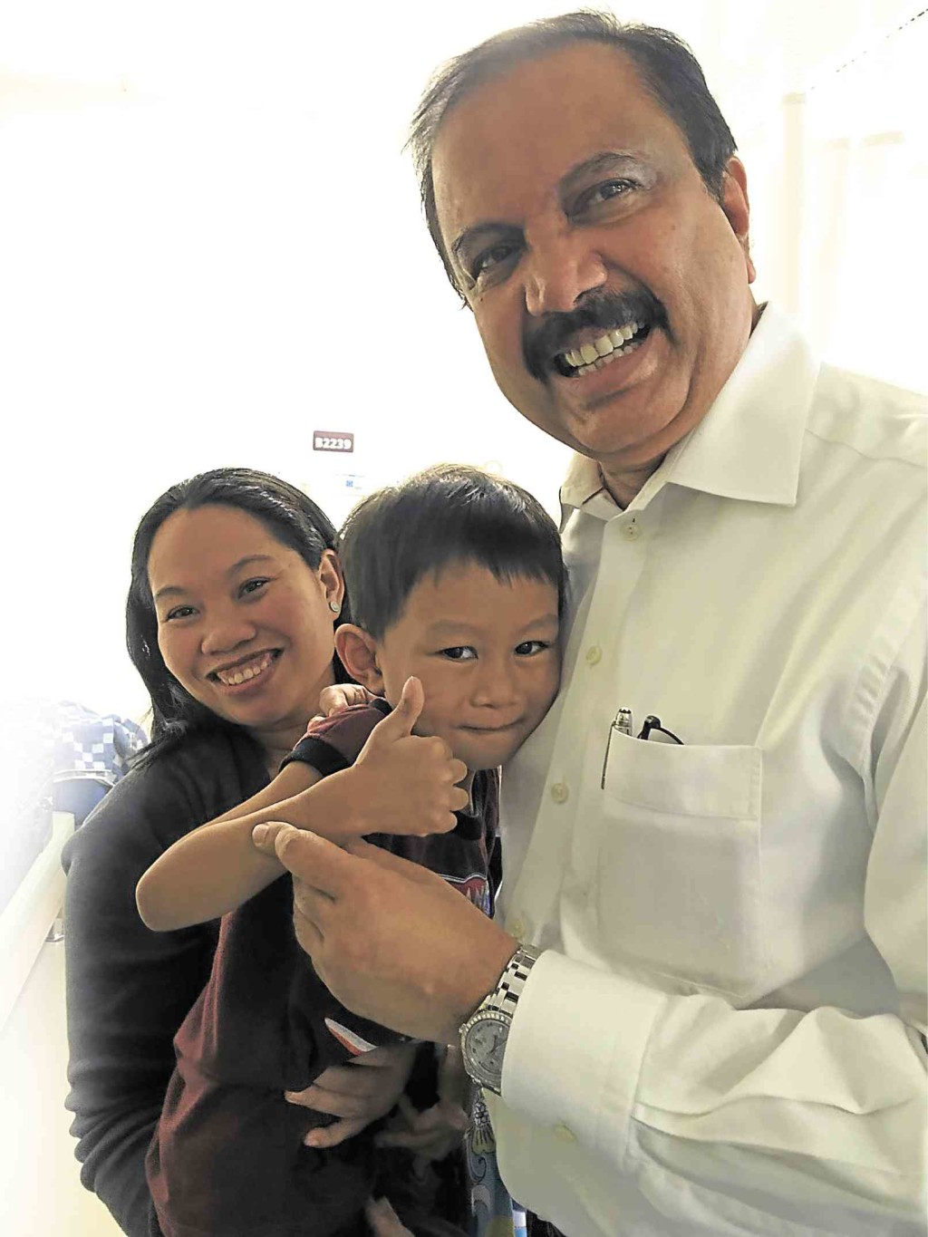 DM Foundation chair Dr. Azad Moopen (right) with Joneil Dasi-an and his mom Richelle after the child’s surgery at the Aster Medcity, Kochi, India