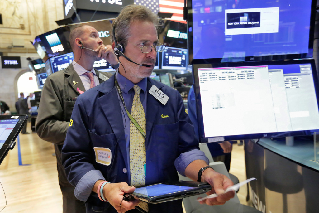 Trader Ronald Madarasz, center, works on the floor of the New York Stock Exchange, Tuesday, Sept. 6, 2016. U.S. stocks indexes are mostly higher in early trading as traders look over the details of several corporate deals. (AP Photo/Richard Drew)