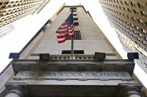 FILE - In this Friday, Nov. 13, 2015, file photo, the American flag flies above the Wall Street entrance to the New York Stock Exchange. U.S. stock indexes edged lower in morning trading Wednesday, Sept. 7, 2016, weighed down by a slide in supermarket operators and other consumer-focused companies. Materials stocks also were among the big decliners. A sharp drop in hiring in August 2016 overshadowed a report Wednesday showing a pickup in job openings in July. (AP Photo/Richard Drew, File)