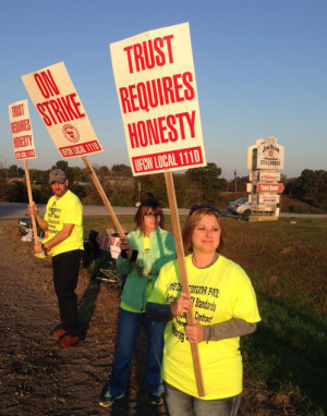 Workers hold picket signs outside the Jim Beam plant in Clermont, Ky., on Saturday, Oct. 15, 2016. More than 200 union workers walked off their jobs at Beam distilleries at Clermont and Boston in Kentucky after voting Friday to reject the latest contract offer from the world's leading bourbon producer. AP