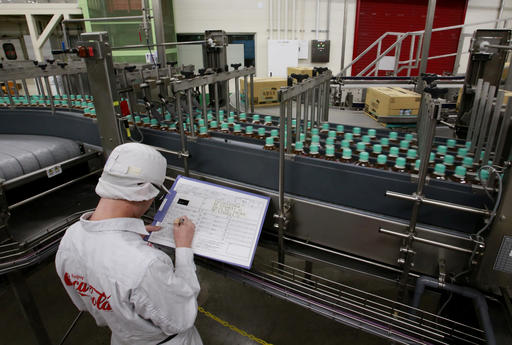 In this Nov. 17, 2016 photo, a worker watches a product line at Coca-Cola Ebina plant in Ebina, Kanagawa Prefecture, near Tokyo. At Coca-Cola’s plant in Ebina, bottles and caps are each splashed with a decontaminating chemical, and then rinsed with blasts of water. Bottles filled with tea from giant vats flash by, 900 per minute. They’re inspected, labeled and then boxed in robotic lines: a non-stop parade of bottled teas circling the plant round-the-clock. AP