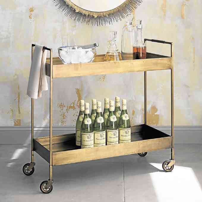 Barware and beverages remain close at hand on this bar cart burnished with the glow of yesteryear.
