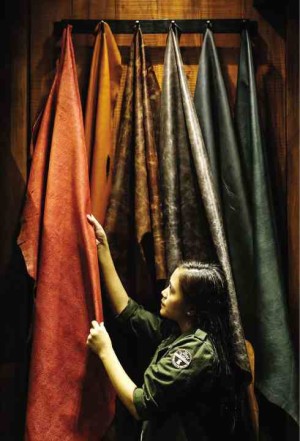 Staffer Kim Villaluz inspects the cow leather in different colors on display in a corner of The Tannery Manila.