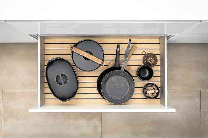 The SieMatic GripDeck prevents pots, pans, and plates from  rattling around in drawers and pullouts.