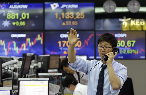 A currency trader works at the foreign exchange dealing room of the KEB Hana Bank headquarters in Seoul, South Korea. AP