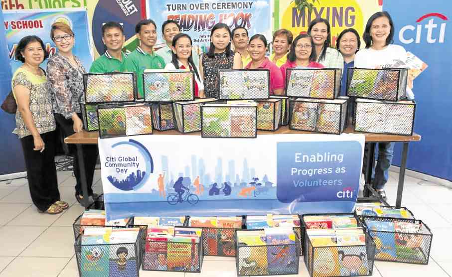 Aneth Lim, Citi Philippines Public Affairs and Corporate Citizenship Director, (center) joins Nangka Elementary School teachers and officials as well as representatives from the Philippine Business for Social Progress during the turnover of the reading nooks.