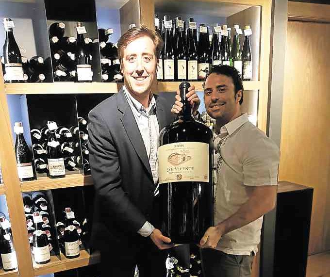 Jose Antonio Allona of Sierra Cantabria wines holds a San Vicente magum with Txanton's Besai Gonzalez