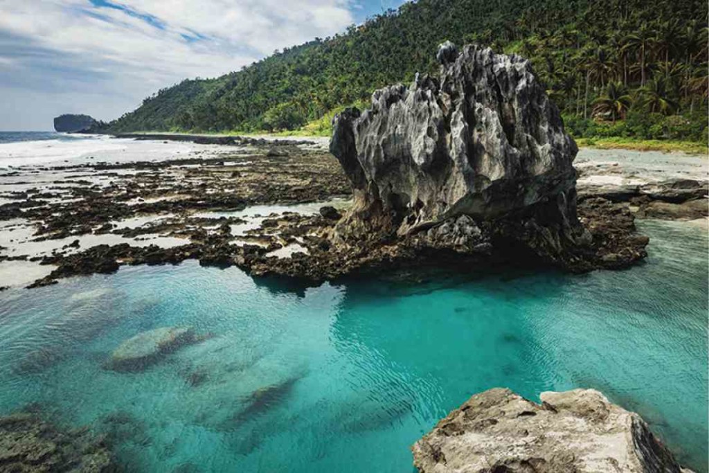 A tidal pool in a concave rock formation during low tide at the beaches of Casiguran, Aurora