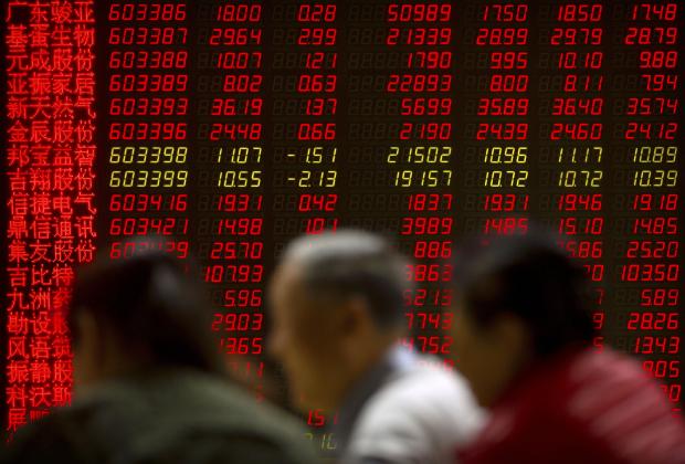 Chinese investors in front of stock monitor