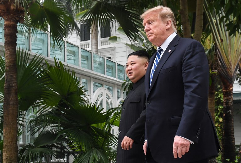 US President Donald Trump (R) walks with North Korea's leader Kim Jong Un during a break in talks at the second US-North Korea summit at the Sofitel Legend Metropole hotel in Hanoi on February 28, 2019. (Photo by Saul LOEB / AFP)