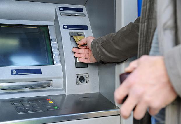 Man inserting card in ATM, FOR STORY: PH must step up digital shift for better aid system – WB