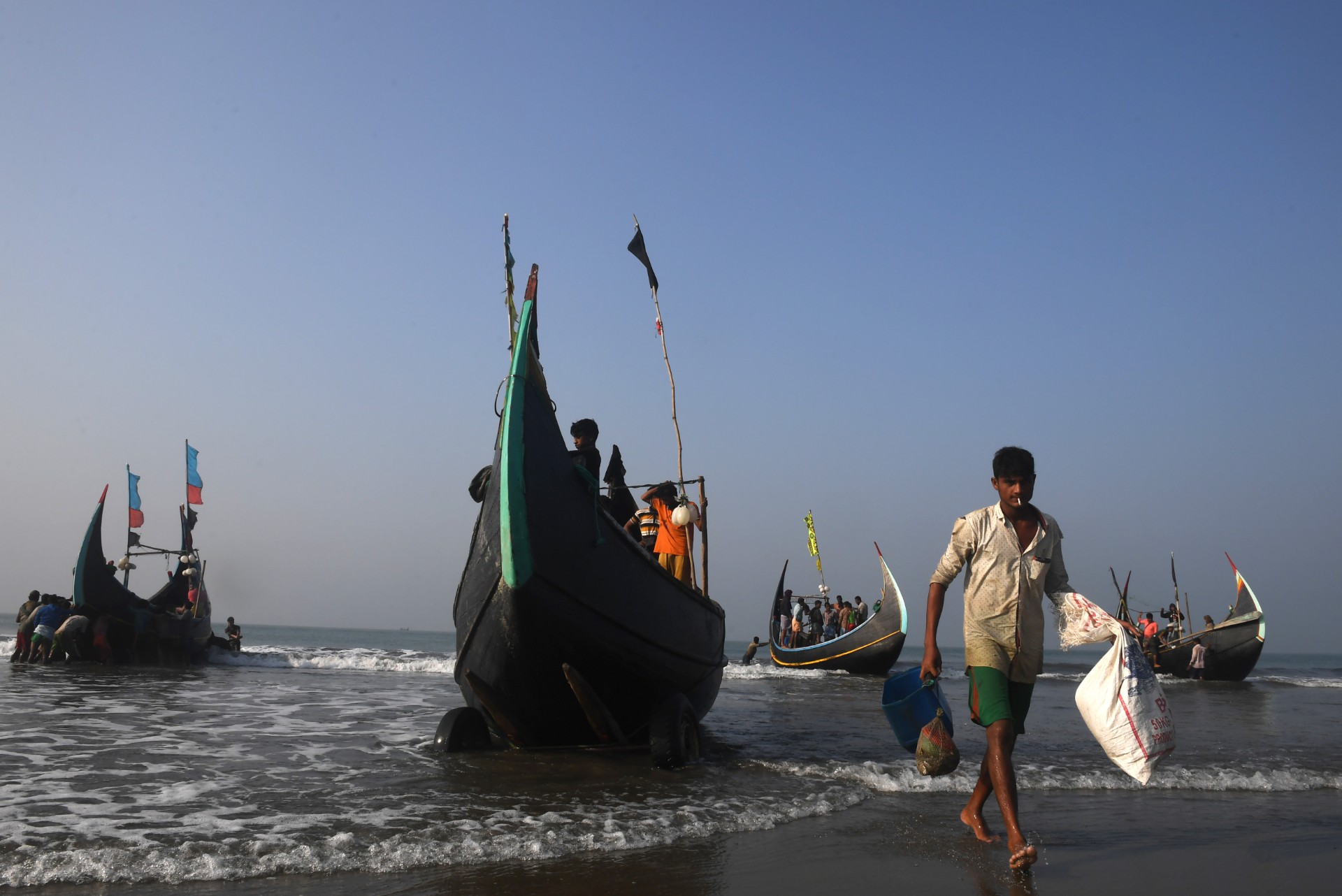 Bangladeshi fishermen return from the sea on their fishing boats at Shaplapur fishing village in the Ukhia area of Bangladesh on November 17, 2018.  AFP FILE PHOTO