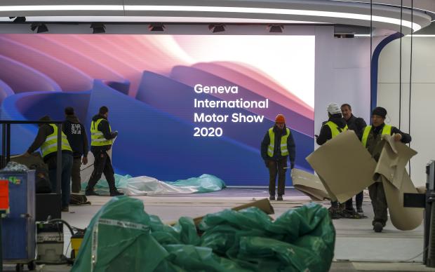 Workers dismantling booth at 90th Geneva International Motor Show