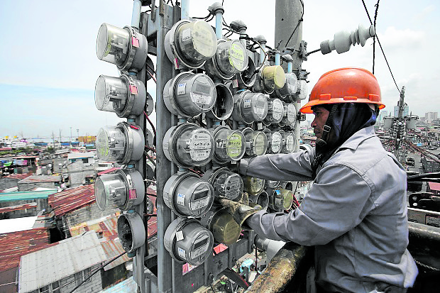 Man reads electric meters STORY: SMC plant stops supplying Meralco
