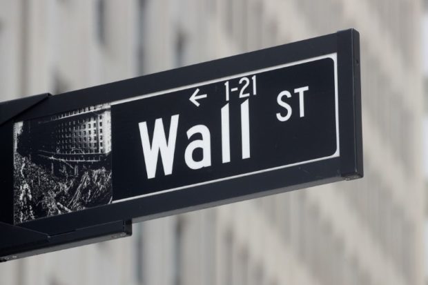 The Wall St. sign is seen near the New York Stock Exchange (NYSE) in New York City, U.S., May 4, 2021.  REUTERS/Brendan McDermid