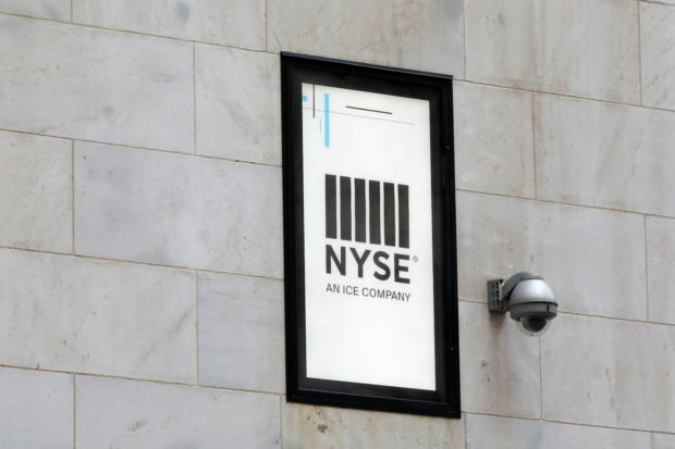 A security camera is seen next to signage outside of the New York Stock Exchange (NYSE) in New York City, New York, U.S., June 28, 2021. REUTERS/Andrew Kelly