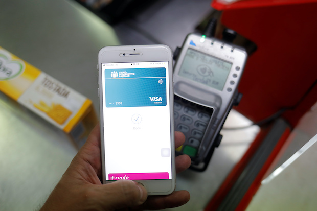 A shopper uses the mobile payment service Apple Pay at a supermarket, amid the coronavirus disease (COVID-19) outbreak, in Ronda