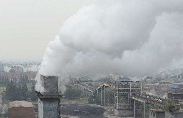 FILE PHOTO: Smoke billows from a chimney at a coking factory in Hefei, Anhui province October 2, 2010. REUTERS/Stringer/File Photo