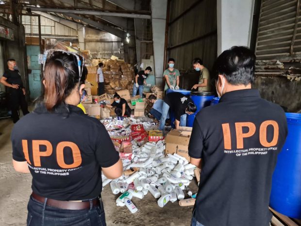 IPOPHL's IEO joins the Bureau of Customs in destroying counterfeit items in a Bulacan warehouse in July 2021