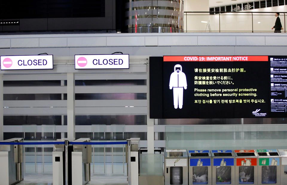 COVID-19 safety measures is pictured next to closed doors at a departure hall of Narita international airport
