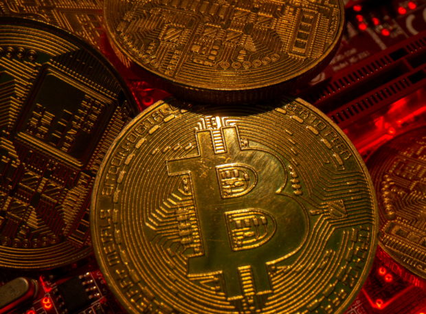 FILE PHOTO: Representations of the virtual currency Bitcoin stand on a motherboard in this picture illustration taken May 20, 2021. REUTERS/Dado Ruvic/File Photo