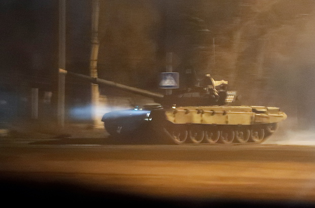 A tank drives along a street in Donetsk, for story: Explainer: How Western sanctions might target Russia