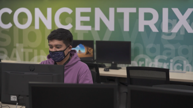 FILE PHOTO A BPO worker wears his face mask while working. 
