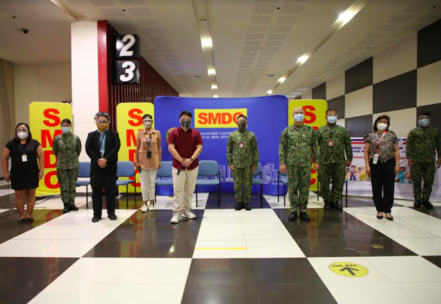 People Standing with soldiers in SMDC's The Good Guys Job Market