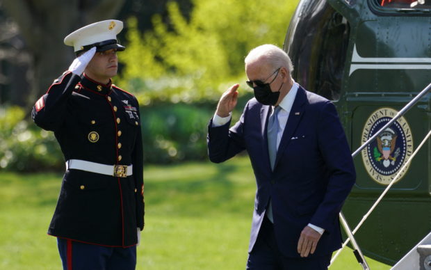 U.S. President Joe Biden returns a salute as he steps from Marine One upon arrival at the White House in Washington, U.S., April 11, 2022. REUTERS/Kevin Lamarque
