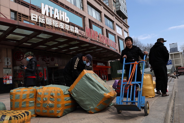 Men move bags of goods for export in front of a trading center that houses shops and offices with Russian goods and services, in Beijing. STORY: Russia sees trade with China reaching $200B by 2024