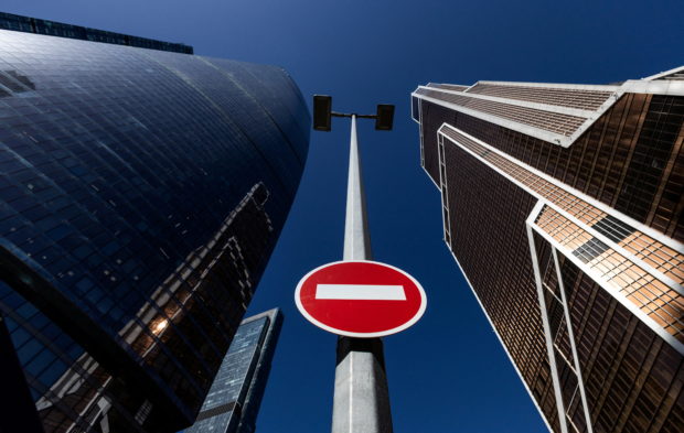 FILE PHOTO: A stop road sign is seen next to skyscrapers at Moscow International business centre, also known as "Moskva-City", in Moscow, Russia April 14, 2022. REUTERS/Maxim Shemetov