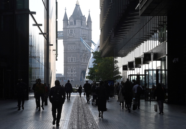 Workers walk towards Tower Bridge during the morning rush hour in London. STORY: High UK inflation hastens ‘real living wage’ announcement