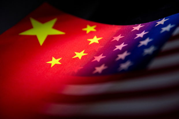 FILE PHOTO: China's and U.S.' flags are seen printed on paper in this illustration taken January 27, 2022. REUTERS/Dado Ruvic/Illustration