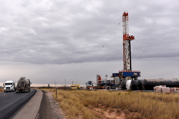 A drilling rig operates in in New Mexico. STORY: Oil tops $120 a barrel on Saudi pricing despite OPEC+ deal