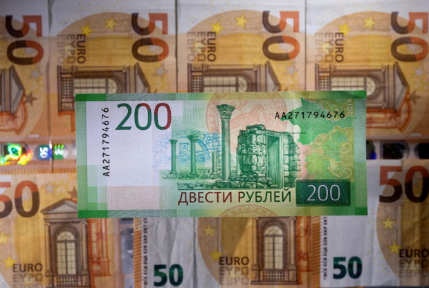 FILE PHOTO: A Russian rouble banknote is placed on euro banknotes in this illustration taken March 1, 2022. REUTERS/Dado Ruvic/Illustration