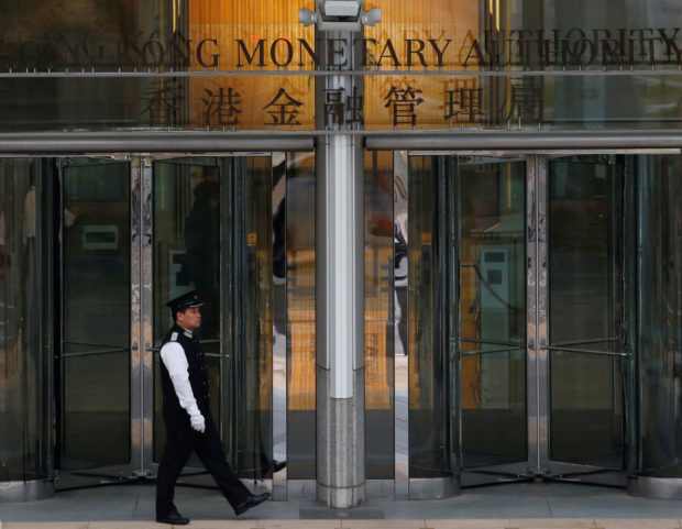 A man walking outside HK Monetary Authority building