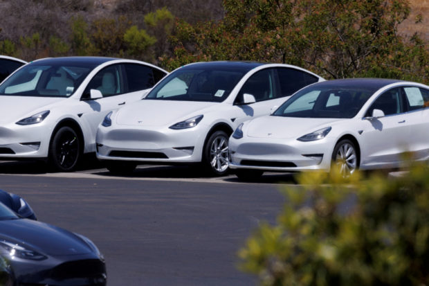 white Tesla electric cars parked