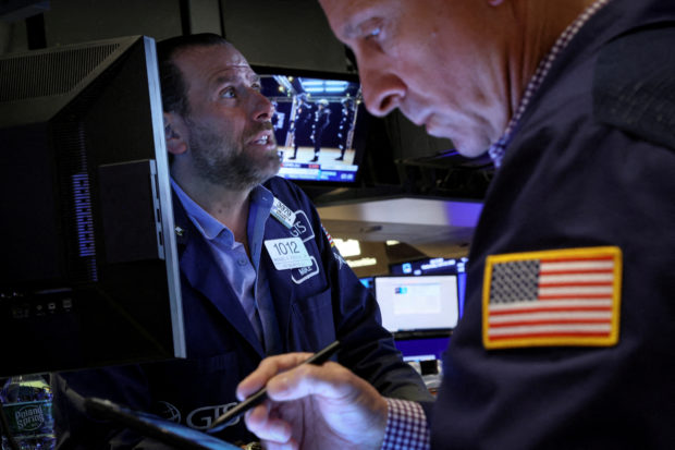 Traders work on the floor of NYSE