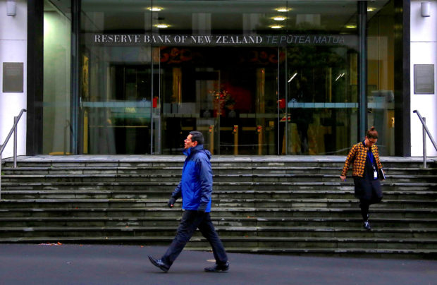 Pedestrians walking in front of Reserve Bank of New Zealand's main entrance