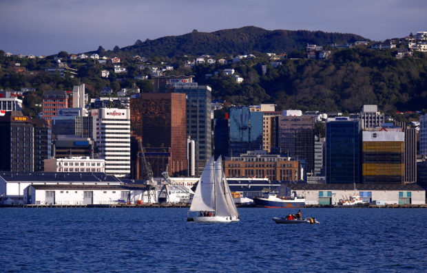 Sailing boat in front of business district in Wellington, New Zealand