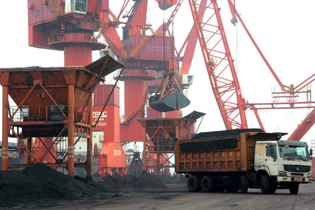 Imported coal is seen lifted by cranes