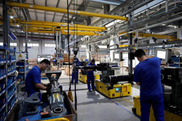 Workers at a production line of vehicle parts