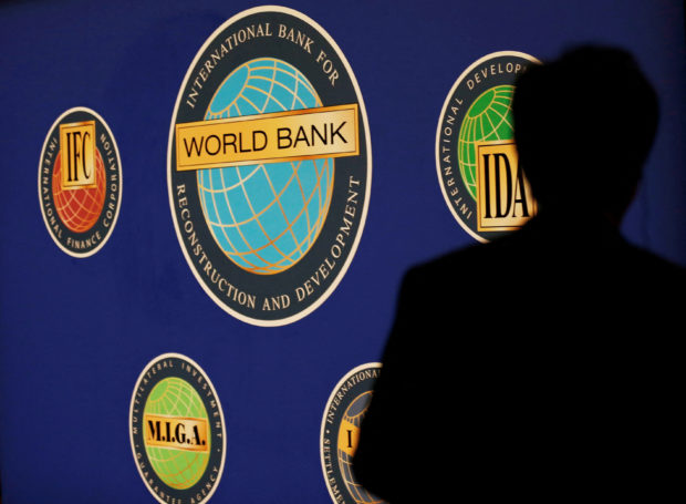 Silhouette of a man against World Bank logo