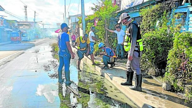 In Zamboanga City, LGU representatives address flooding challenges by declogging, fixing and cleaning drainage canals and pipes.