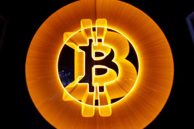 A neon logo of Bitcoin