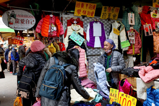 People buying winter jackets in a market in Taipei