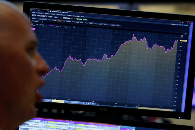 Trader looks at screen that charts S&P 500