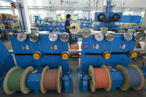 Workers at optical fiber cable manufacturing plant
