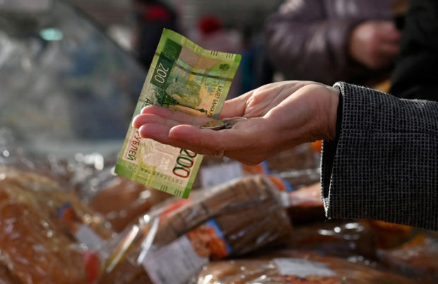 Customer hands over Russian ruble to a vendor